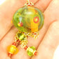 27-inch necklace with large funky glass ball and matching pendants in lime green-red-yellow (Murano-style glass handmade in Montreal), dots and bubbles, gold-toned stainless steel chain