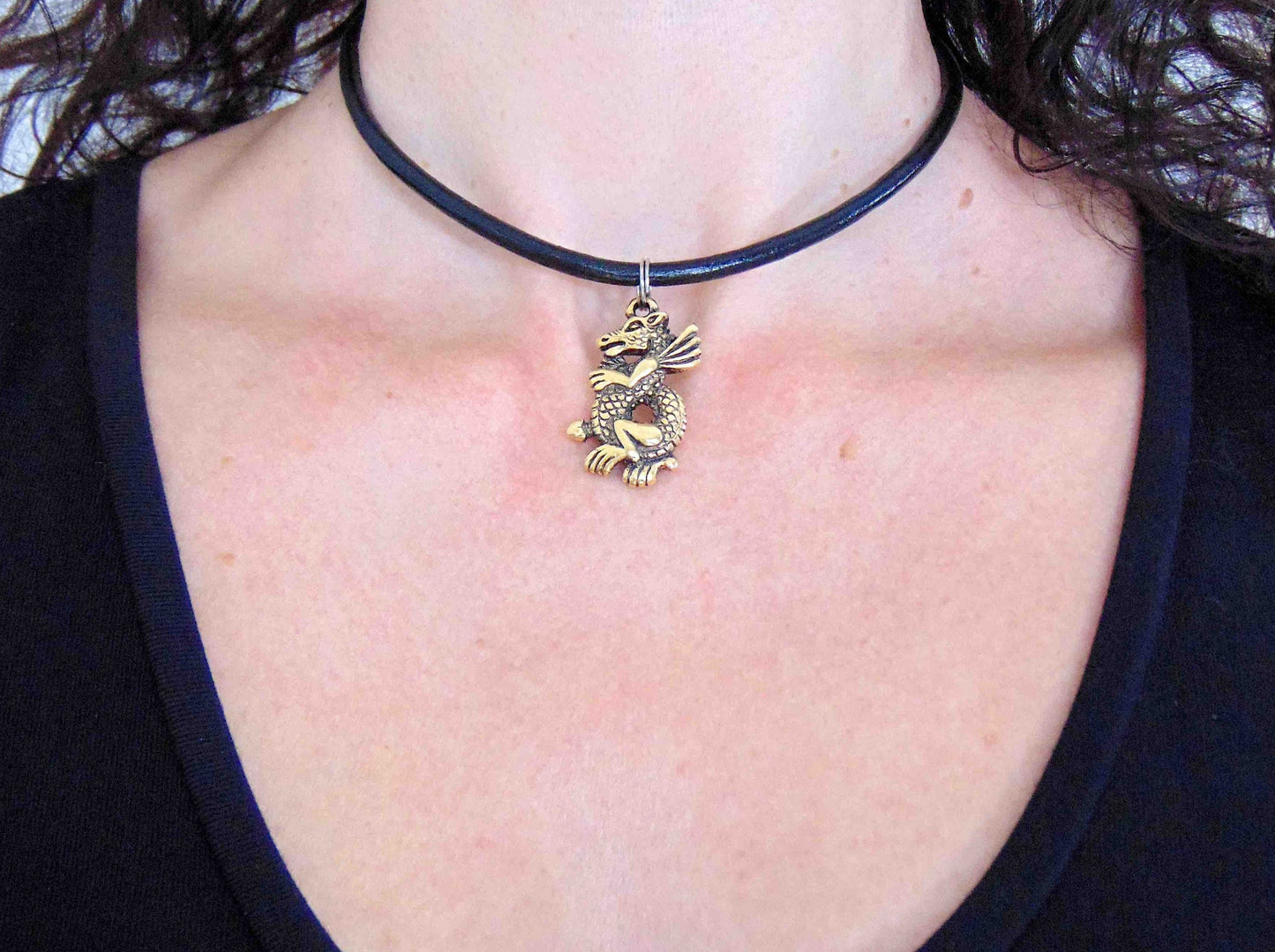 Choker necklace with gold-toned pewter dragon pendant on black leather, stainless steel clasp