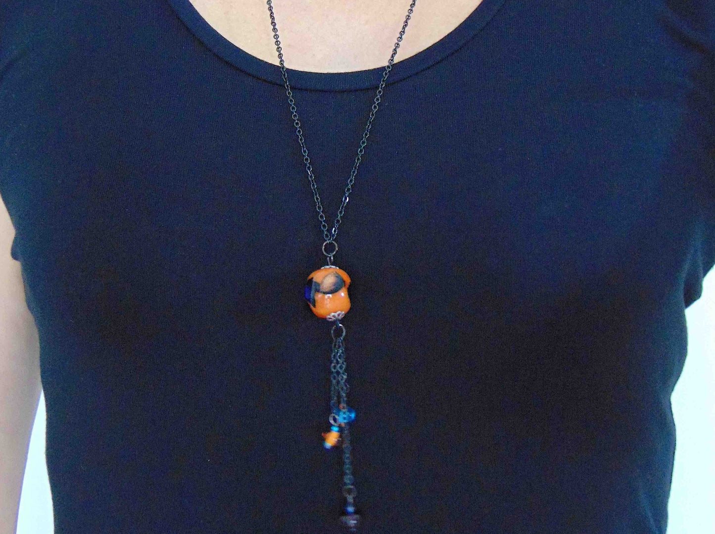 27-inch necklace with elongated glass ball and matching pendants in bright orange-black-blue (Murano-style glass handmade in Montreal), black stainless steel chain