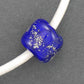 Collier tour de cou avec cylindre de verre bleu minuit (verre style Murano fait main à Montréal), inclusions d'argent véritable, cordon de cuir blanc fini perlé, fermoir acier inoxydable