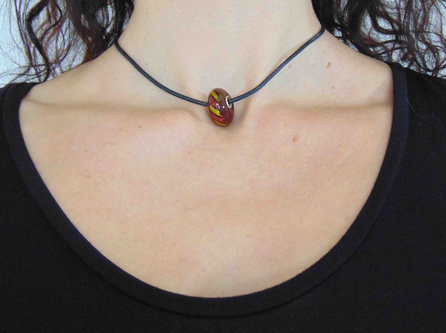 Choker necklace with burgundy red glass bead (Murano-style glass handmade in Montreal), red and yellow cane pattern, black leather cord, stainless steel clasp