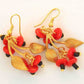 Long earrings with golden leaves and red glass fruits, metal hooks