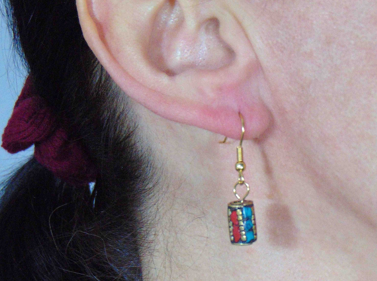 Short earrings with cylindrical brass Tibetan beads, turquoise and coral inserts, gold-toned stainless steel hooks