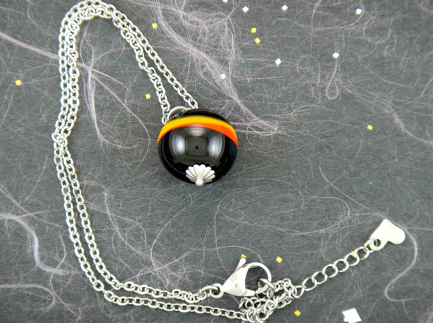 14-inch necklace with funky black ball marbled in red and yellow (Murano-style glass handmade in Montreal), stainless steel chain