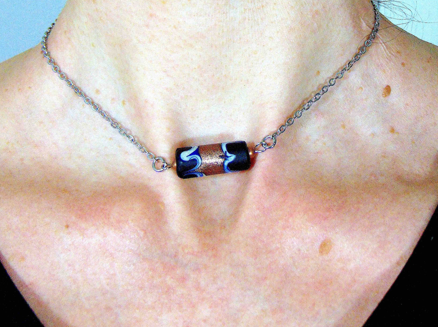 14-inch necklace with matte black Murano glass cylinder, feather pattern and metallic bronze center, stainless steel chain
