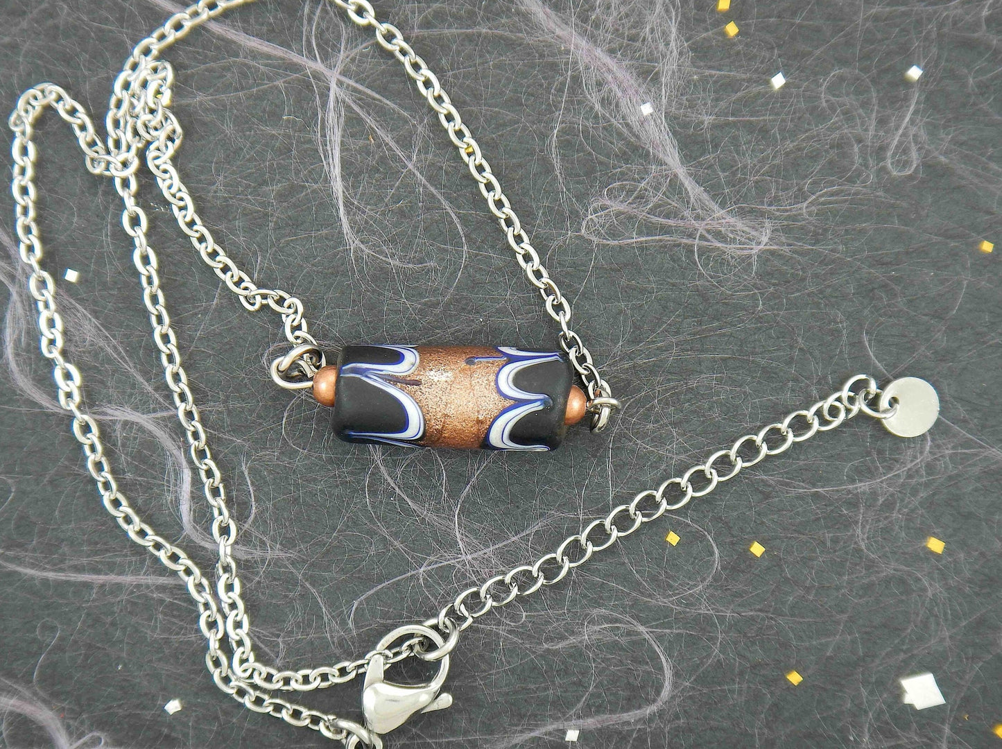 14-inch necklace with matte black Murano glass cylinder, feather pattern and metallic bronze center, stainless steel chain