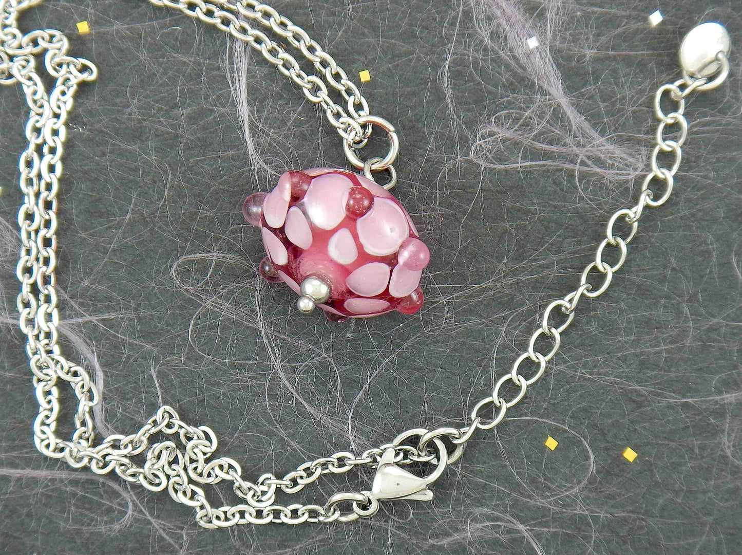 14-inch necklace with dark pink saucer-shaped Murano glass bead, 3-dimensional light pink and white dots, stainless steel chain