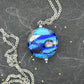 29-inch necklace with Murano glass round pendant marbled in dark blue, turquoise, black and white, stainless steel chain