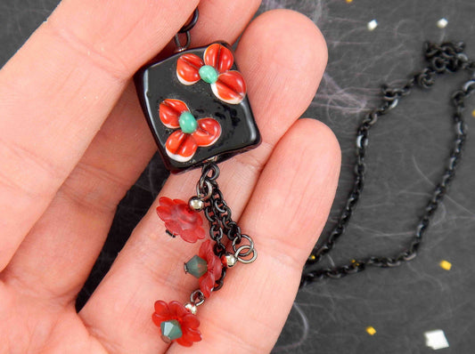 24-inch necklace with black Murano glass square, red-green 3D flowers, pendants with vintage lucite flowers and green Swarovski crystals, black stainless steel chain