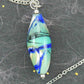 29-inch necklace with Murano glass pointed cylinder marbled in dark blue, light green, black and white, stainless steel chain