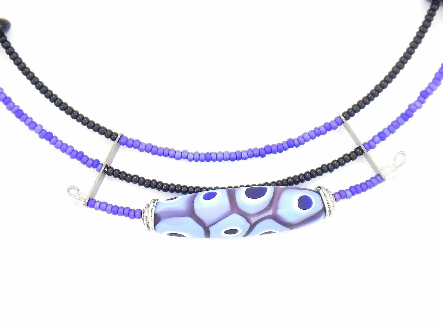 Short asymmetric necklace with matte lilac and black Murano glass bead, eye-dot pattern, metal clasp