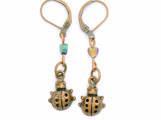 Short earrings with copper ladybugs and tiny iridescent hematite hearts, copper-coloured lever back metal hooks