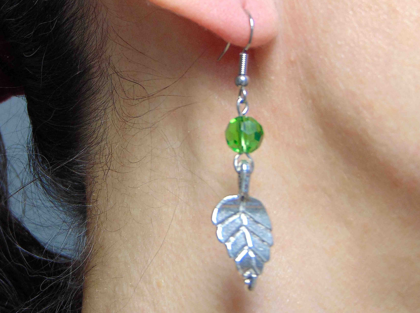 Long earrings with pewter leaves and green faceted crystal balls, stainless steel hooks
