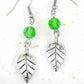 Long earrings with pewter leaves and green faceted crystal balls, stainless steel hooks