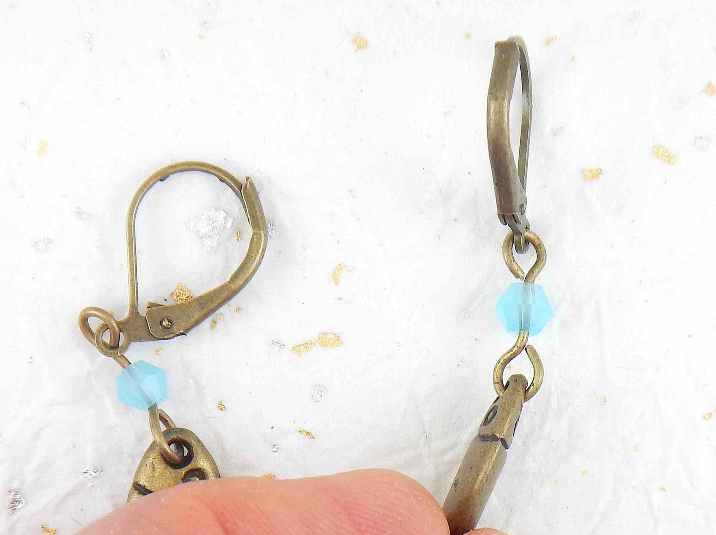 Short earrings with stylized brass fish and bright turquoise Swarovski crystals, brass lever back hooks