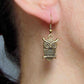 Short earrings with large brass owls sitting on a branch, brass hooks