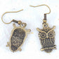 Short earrings with large brass owls sitting on a branch, brass hooks