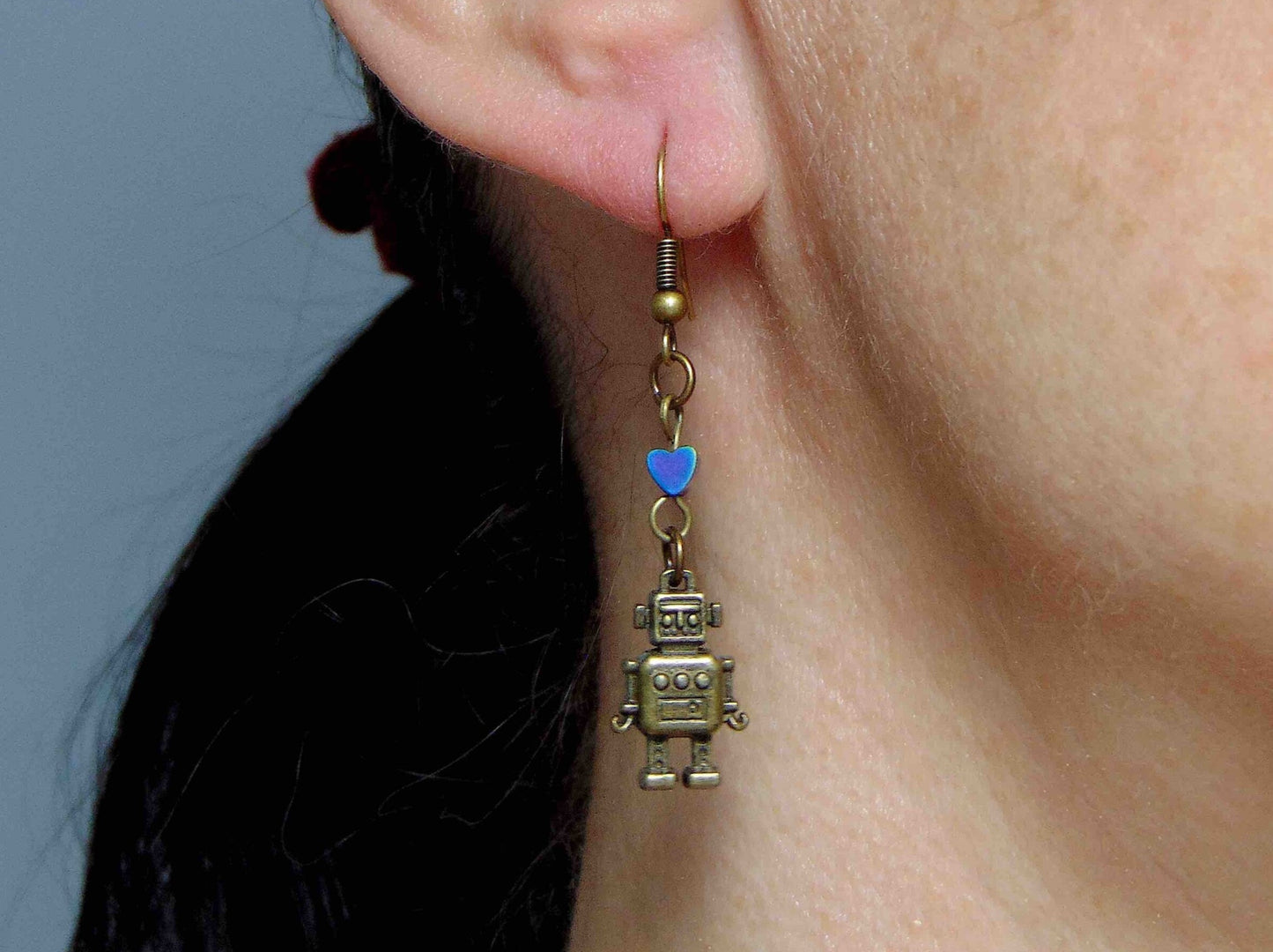 Long earrings with small brass robots and iridescent hematite hearts, brass hooks