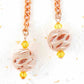 Long earrings with rose gold filigree balls and Swarovski crystals, rose-gold plated metal lever back hooks