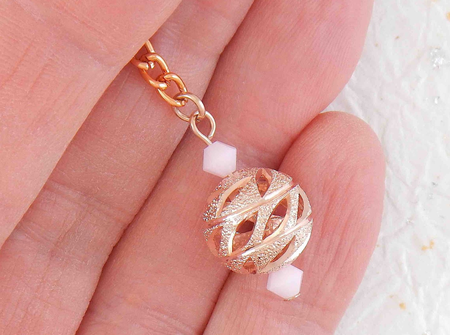 Long earrings with rose gold filigree balls and Swarovski crystals, rose-gold plated metal lever back hooks