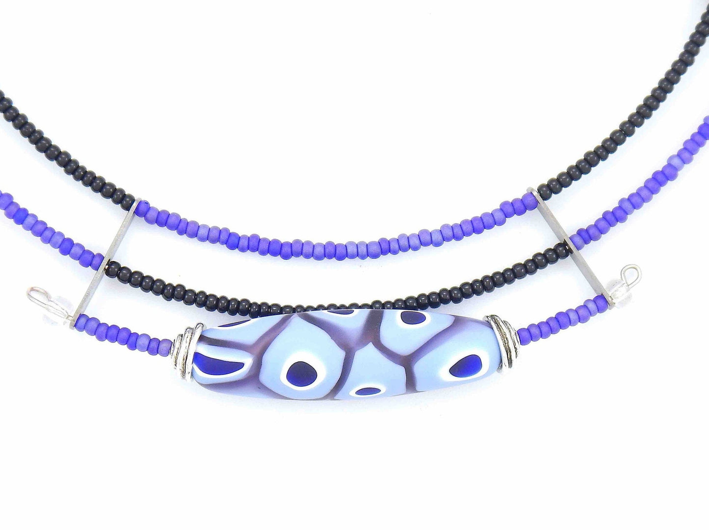 Short asymmetric necklace with matte lilac and black Murano glass bead, eye-dot pattern, metal clasp