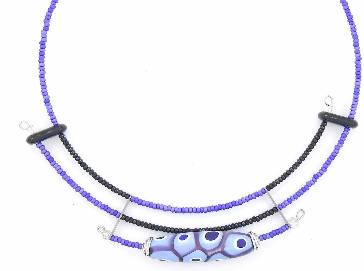 Short asymmetric necklace with matte lilac and black Murano glass bead, eye-dot pattern, metal clasp