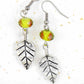 Long earrings with pewter leaves and lime green faceted crystal balls, tiny rose detail, stainless steel hooks