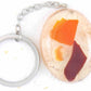 Keychain with handmade resin oval, white beach sand, red and orange glass and shells, stainless steel chain