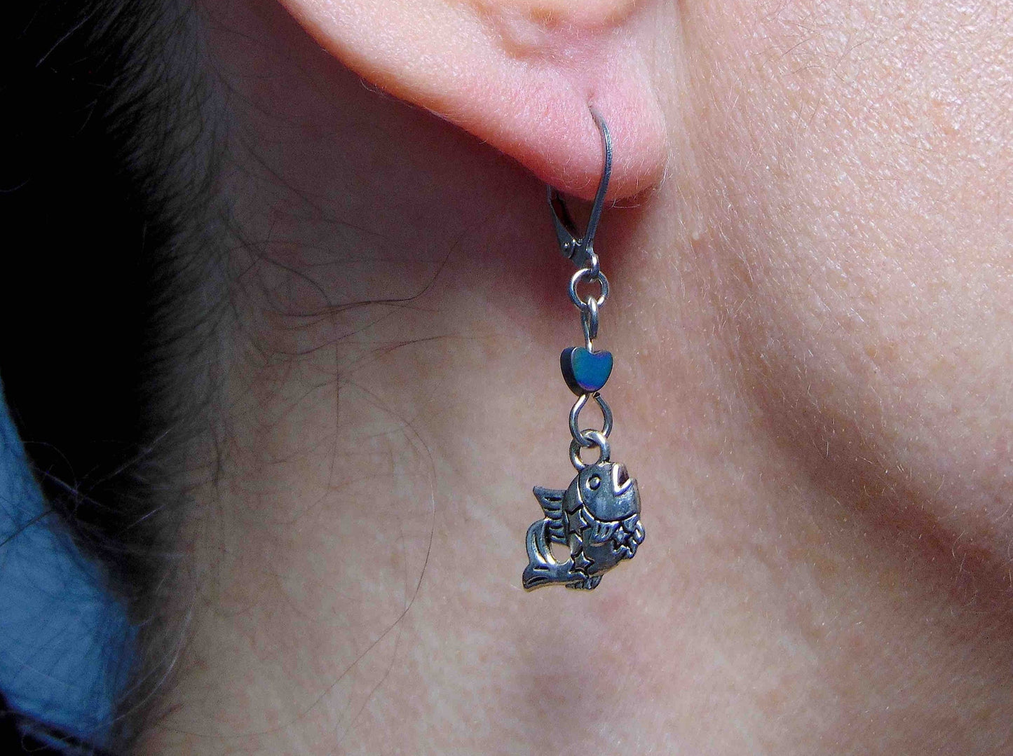 Short earrings with small pewter jumping fish and iridescent hematite hearts, stainless steel lever back hooks