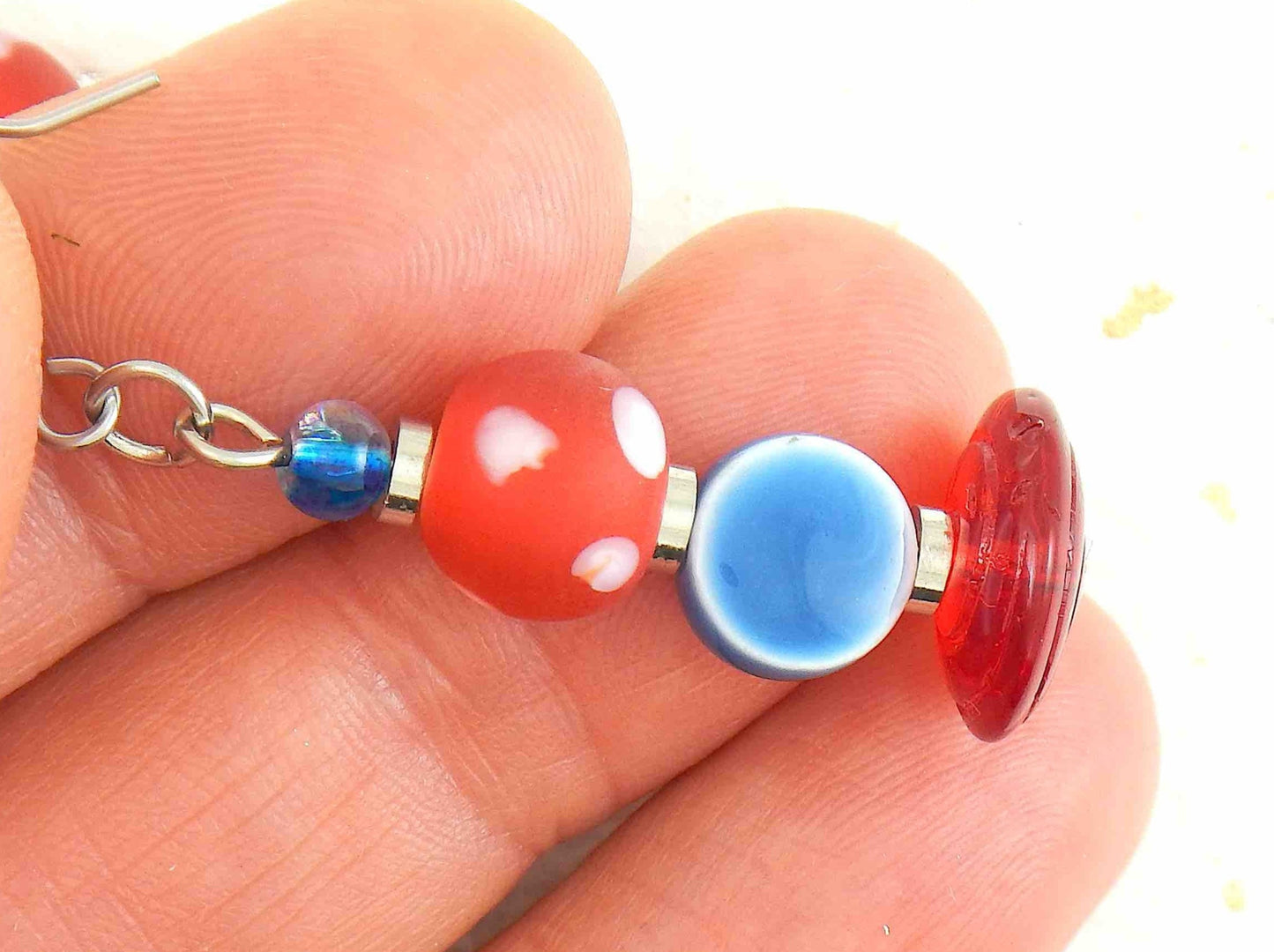 Long earrings with white dotted red balls, blue pellets and translucent red disks, stainless steel hooks