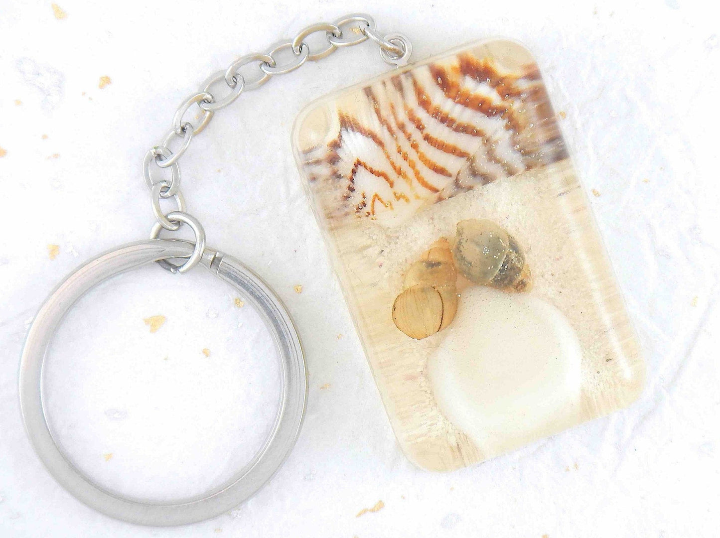 Keychain with handmade resin rectangle, white beach sand, brown and white striped shells, stainless steel chain