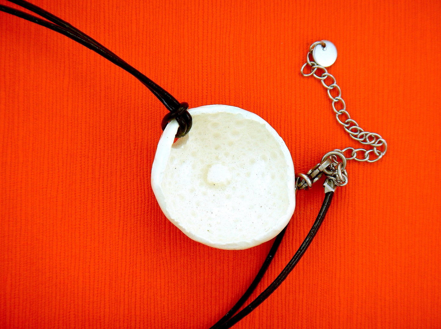 24-inch necklace with off-white ceramic sea urchin pendant handmade in Montreal, black leather cord, stainless steel clasp