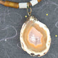 17-inch agate slice pendant in caramel and white on brown leather cord, antique glass cylinder beads, copper clasp