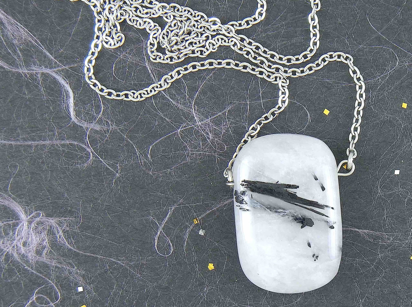 26-inch necklace with rectangular black and white tourmalined quartz stone pendant (a rare mix), stainless steel chain