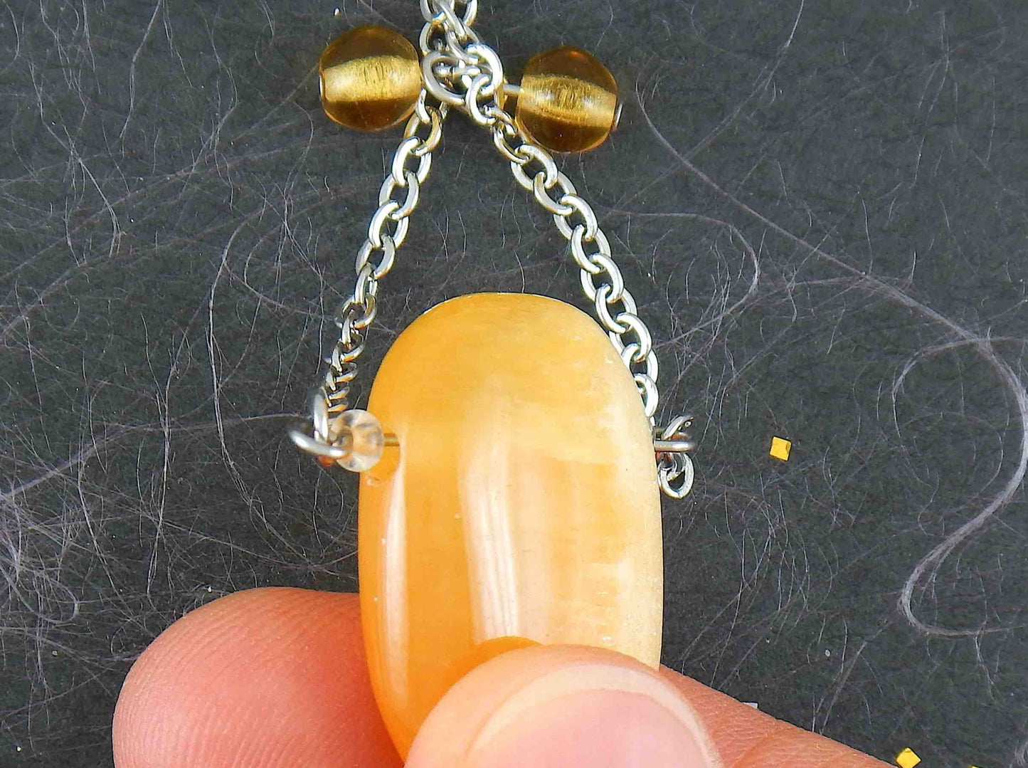 30-inch necklace with large rectangular honey yellow calcite stone pendant, triangular layout, matching glass beads, stainless steel chain