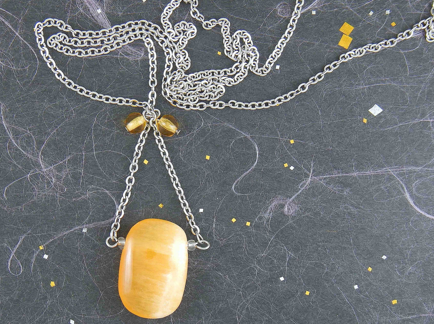 30-inch necklace with large rectangular honey yellow calcite stone pendant, triangular layout, matching glass beads, stainless steel chain