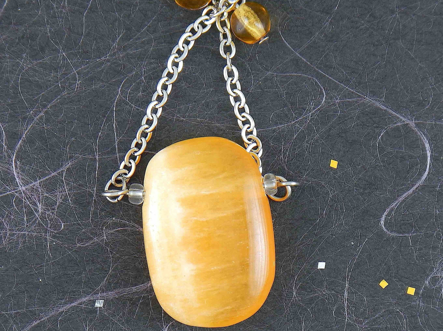 30-inch necklace with large rectangular honey yellow calcite stone pendant, triangular layout, matching glass beads, stainless steel chain