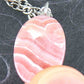 16-inch necklace with oval marbled pink-white rhodocrosite stone pendant, stainless steel chain