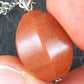 13-inch necklace with pod-shaped copper brown goldstone pendant, stainless steel chain