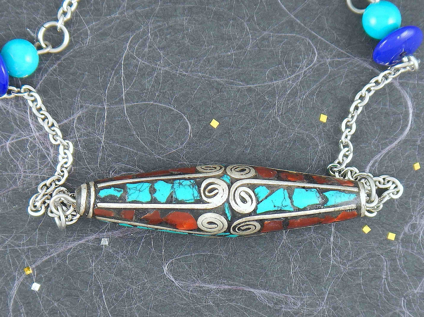 24-inch necklace with Tibetan cylinder bead, turquoise and coral inserts, matching glass beads, stainless steel chain