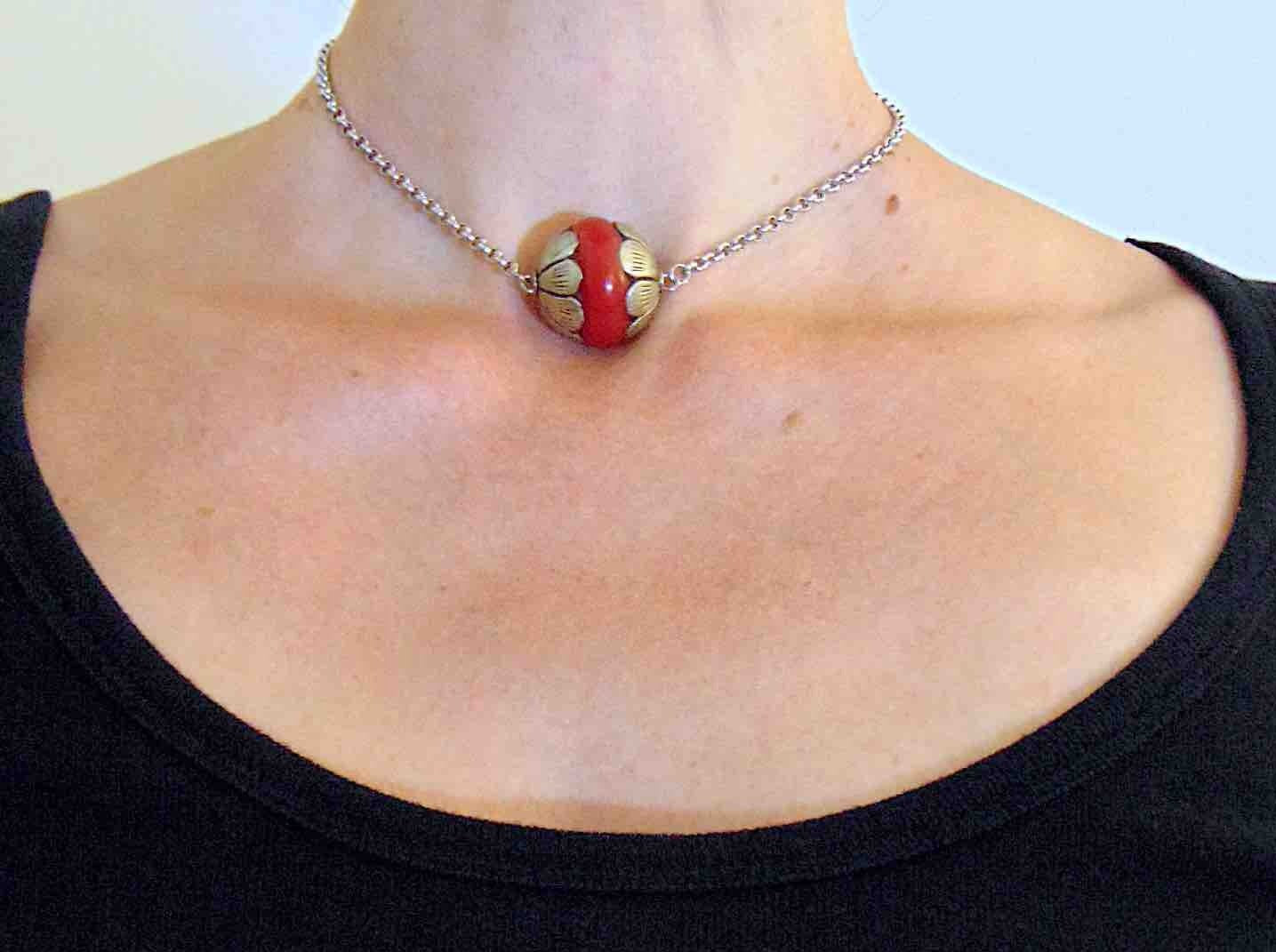 14-inch necklace with pewter and red resin Tibetan ball, stylized flower caps, stainless steel chain