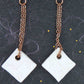 Very long earrings with off-white ceramic lozenges handmade in Montreal, leaf pattern, rose gold plated stainless steel lever back hooks