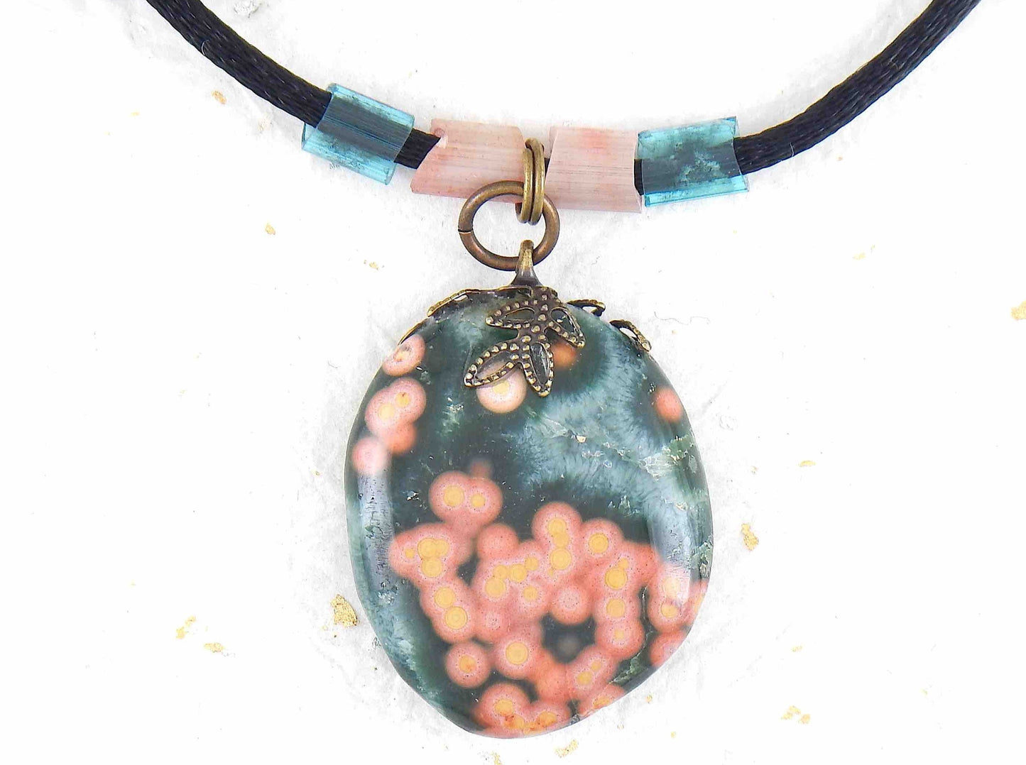 20-inch forest green oval jasper pendant with coral pink dots, black satin cord, antique glass cylinder beads, copper clasp