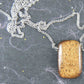 33-inch necklace with smooth rectangular iridescent bronzite stone pendant, stainless steel chain