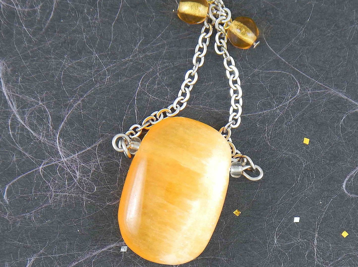 30-inch necklace with large rectangular honey yellow calcite stone pendant, triangular layout, matching glass beads, stainless steel chain