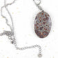 16-inch necklace with oval leopard jasper stone pendant, burgundy and chocolate brown dots on blue-grey background, stainless steel chain