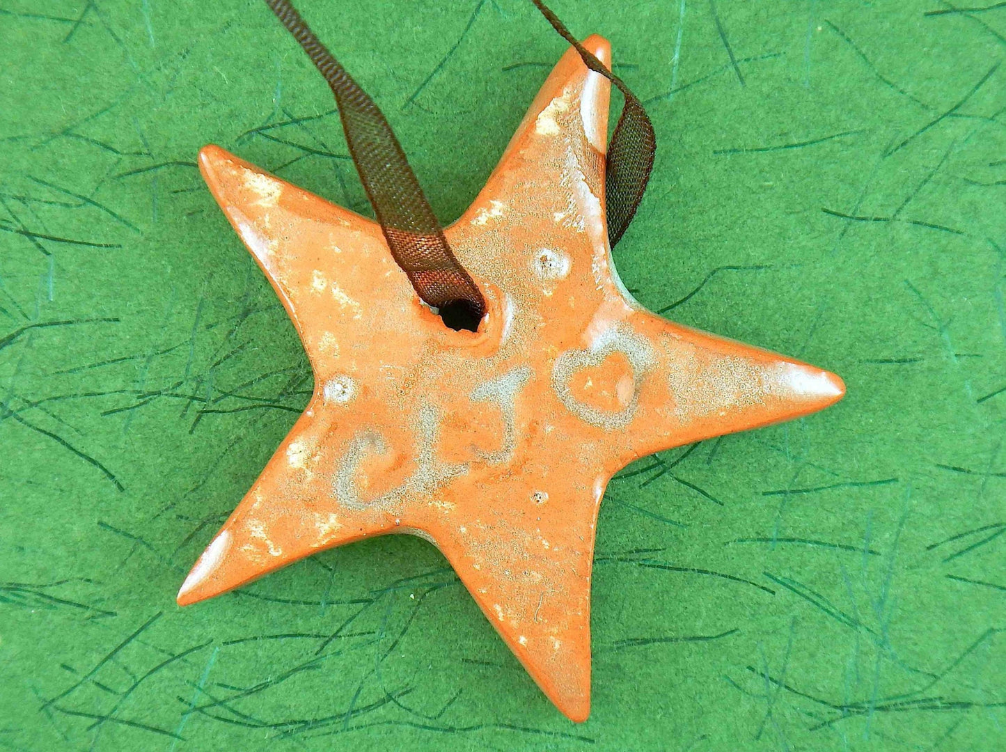Ornament with mint green and terracotta ceramics star handmade in Montreal, chocolate brown organza ribbon