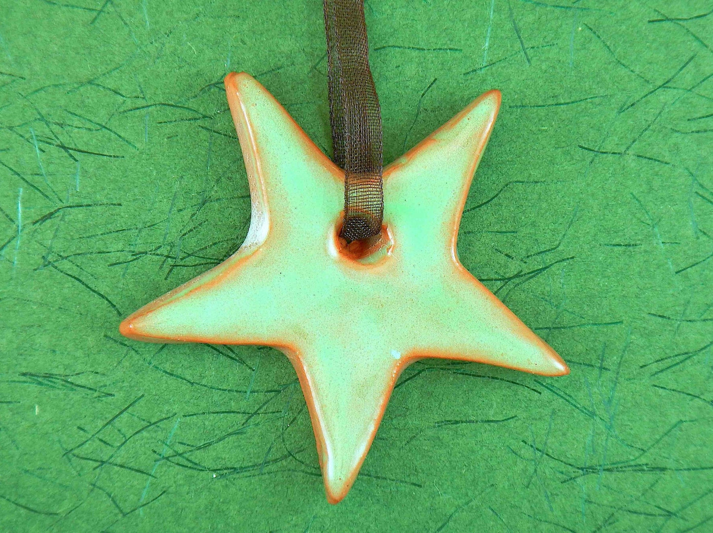 Ornament with mint green and terracotta ceramics star handmade in Montreal, chocolate brown organza ribbon