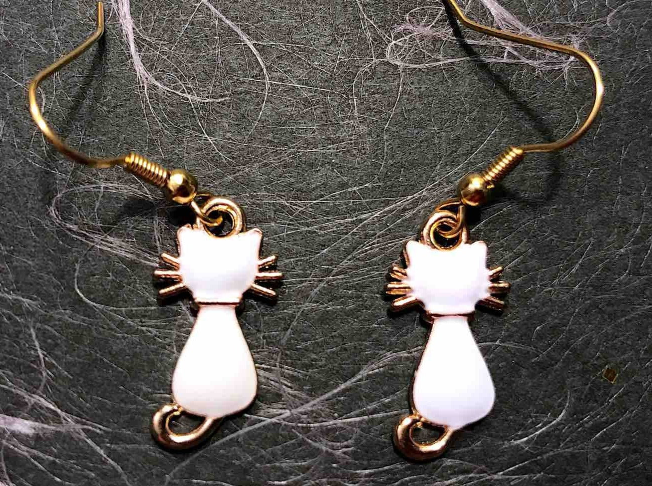 Short earrings with small shiny enamelled white cats, gold-toned stainless steel hooks