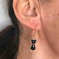 Short earrings with small shiny enamelled black cats, gold-toned stainless steel hooks